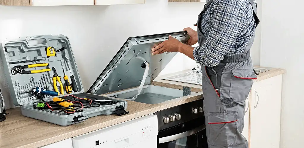Handyman repairing a cooktop and checking wiring connections in Duluth, MN