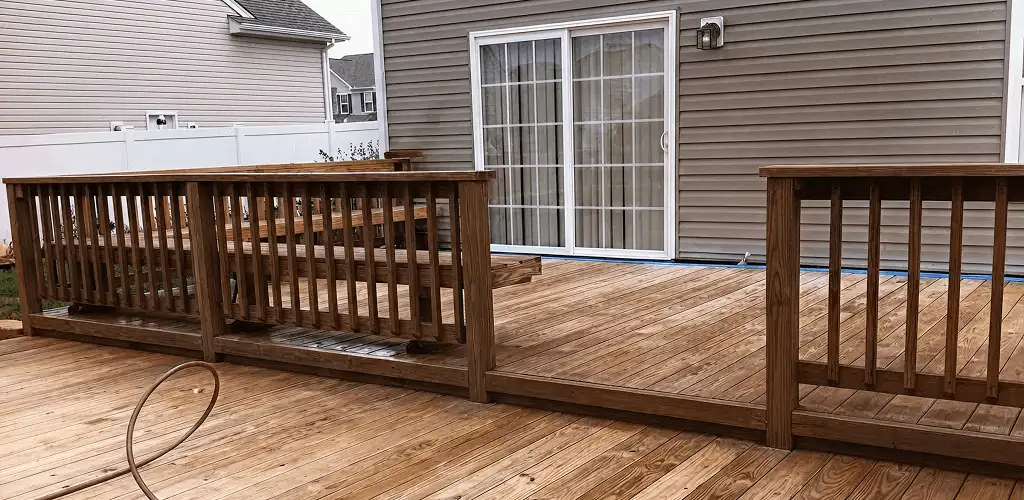 Deck sealing service protecting a backyard wood deck and railings in Duluth, MN