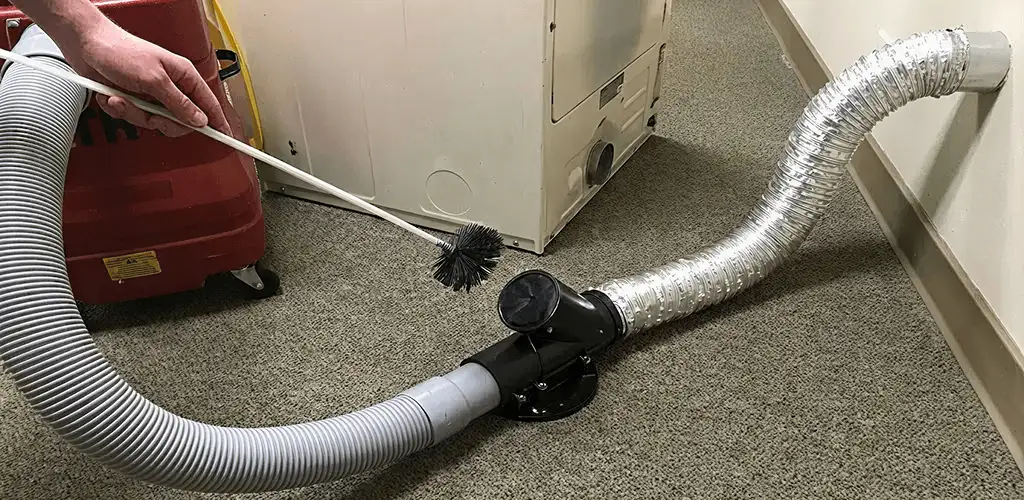Dryer vent cleaning service removing lint from a dryer duct connection in Duluth, MN