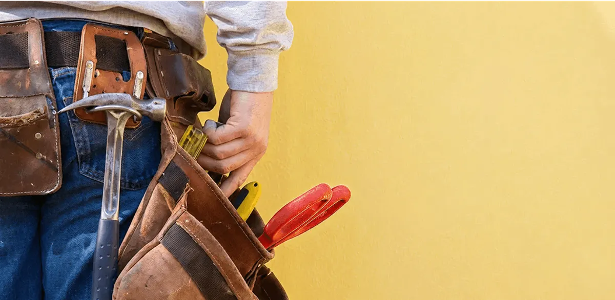Handyman with tool belt ready for home repairs and maintenance in Duluth, MN