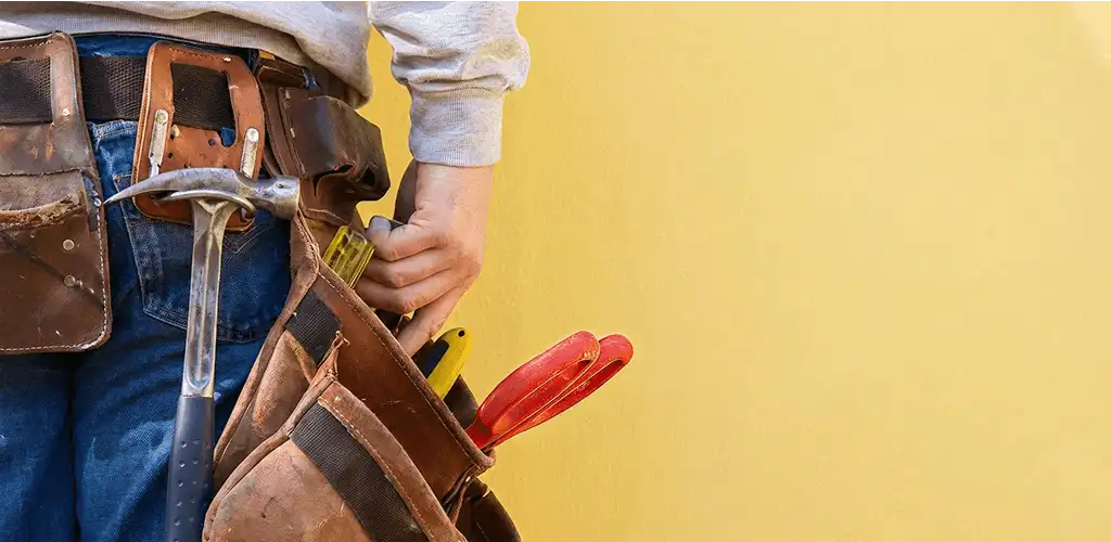 Handyman with tool belt ready for home repairs and maintenance in Duluth, MN