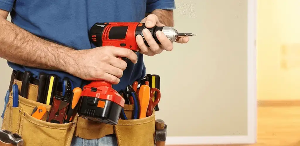 Handyman holding a power drill for home repairs and installations in Duluth, MN
