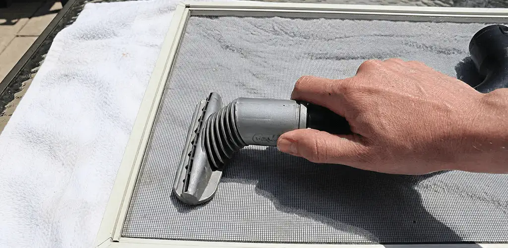 Window screen repair cleaning and fixing a damaged screen mesh in Duluth, MN